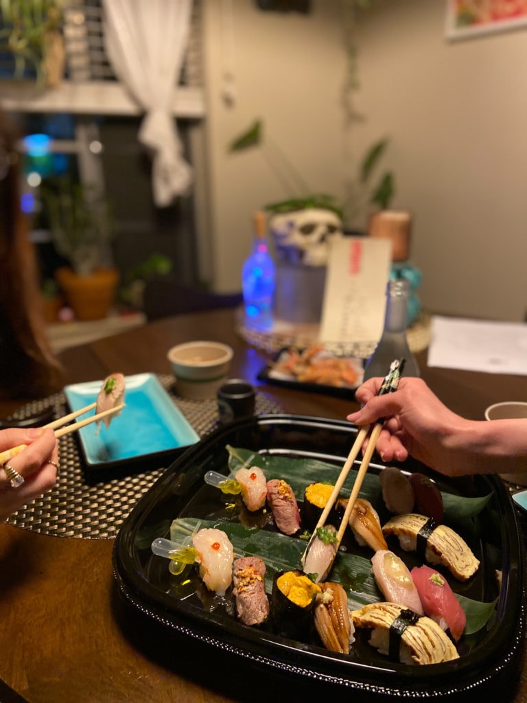 a woman sitting at a table with a plate of food