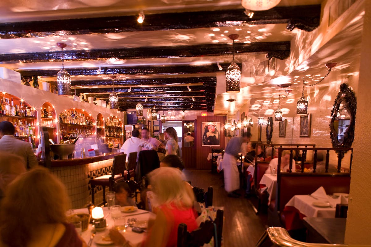 a group of people sitting at a table in a restaurant