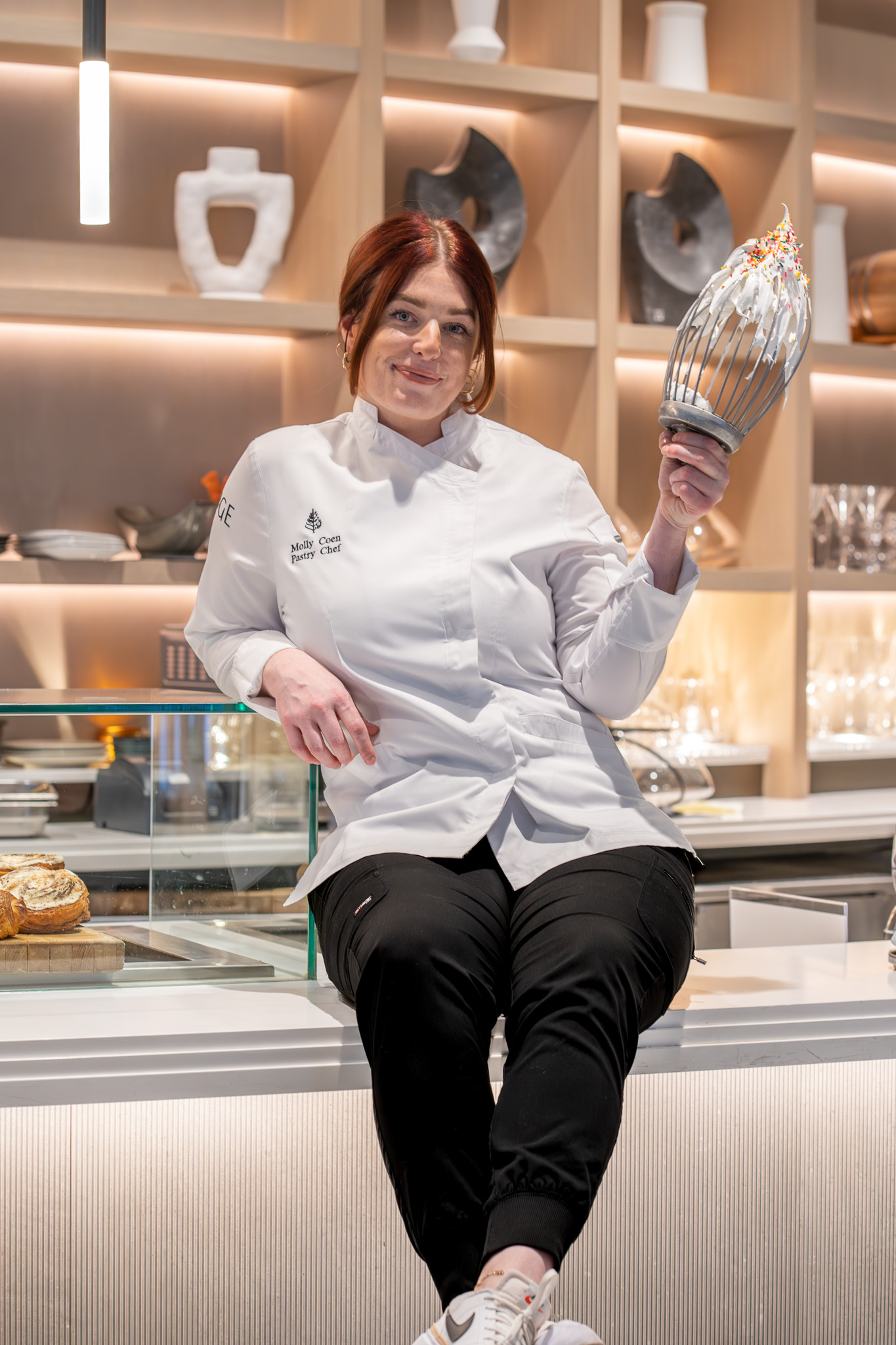a woman standing in front of a window