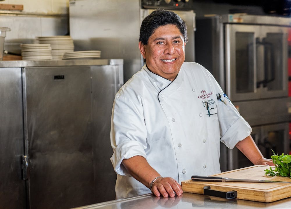 a man standing in a kitchen preparing food