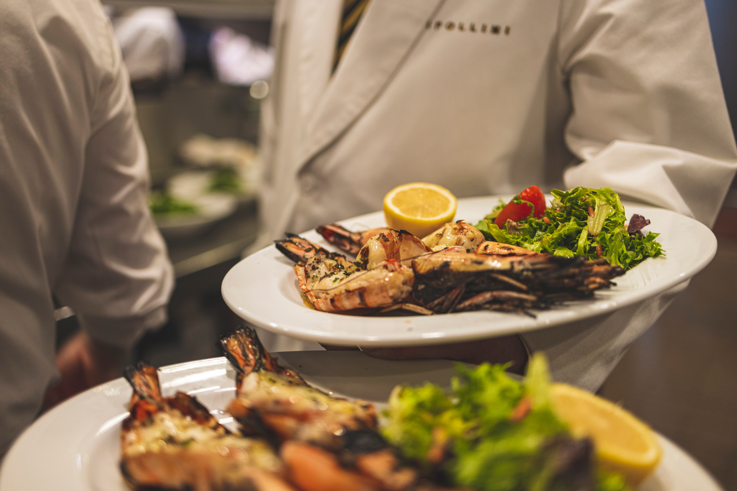a person sitting at a table with a plate of food
