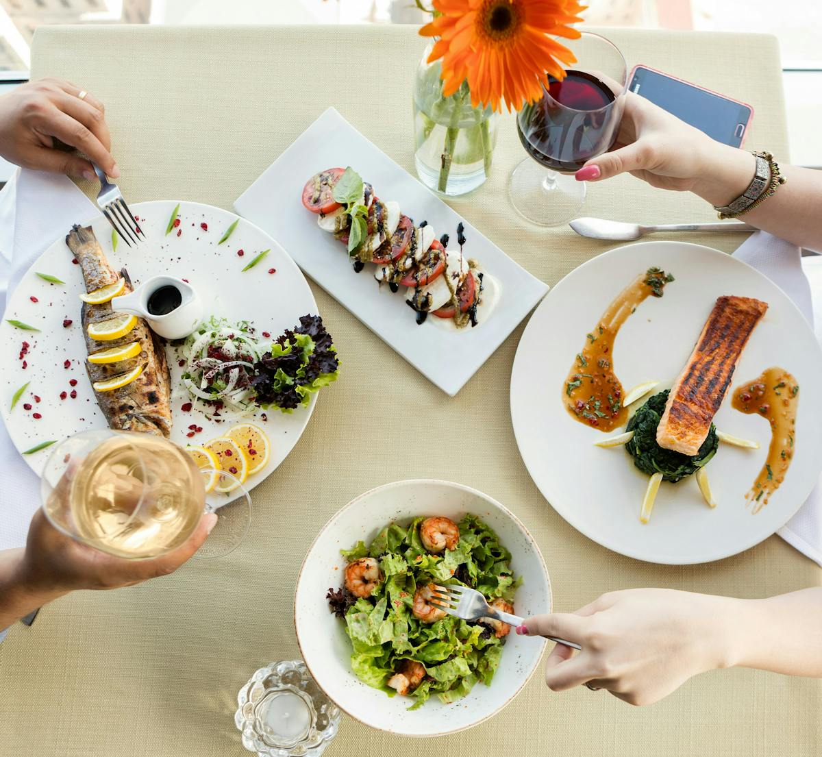 a woman holding a plate of food on a table