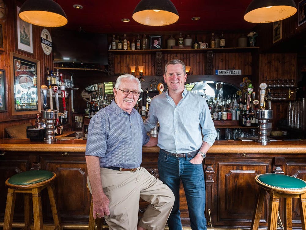 a man and a woman standing in front of a restaurant