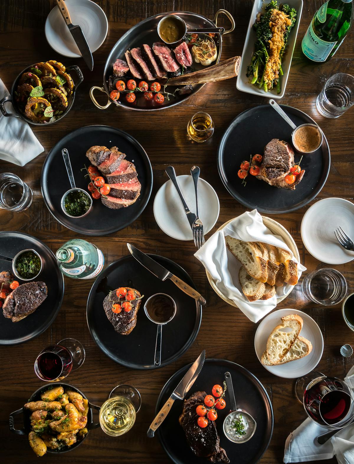 an overview of a table filled with multiple plates of food