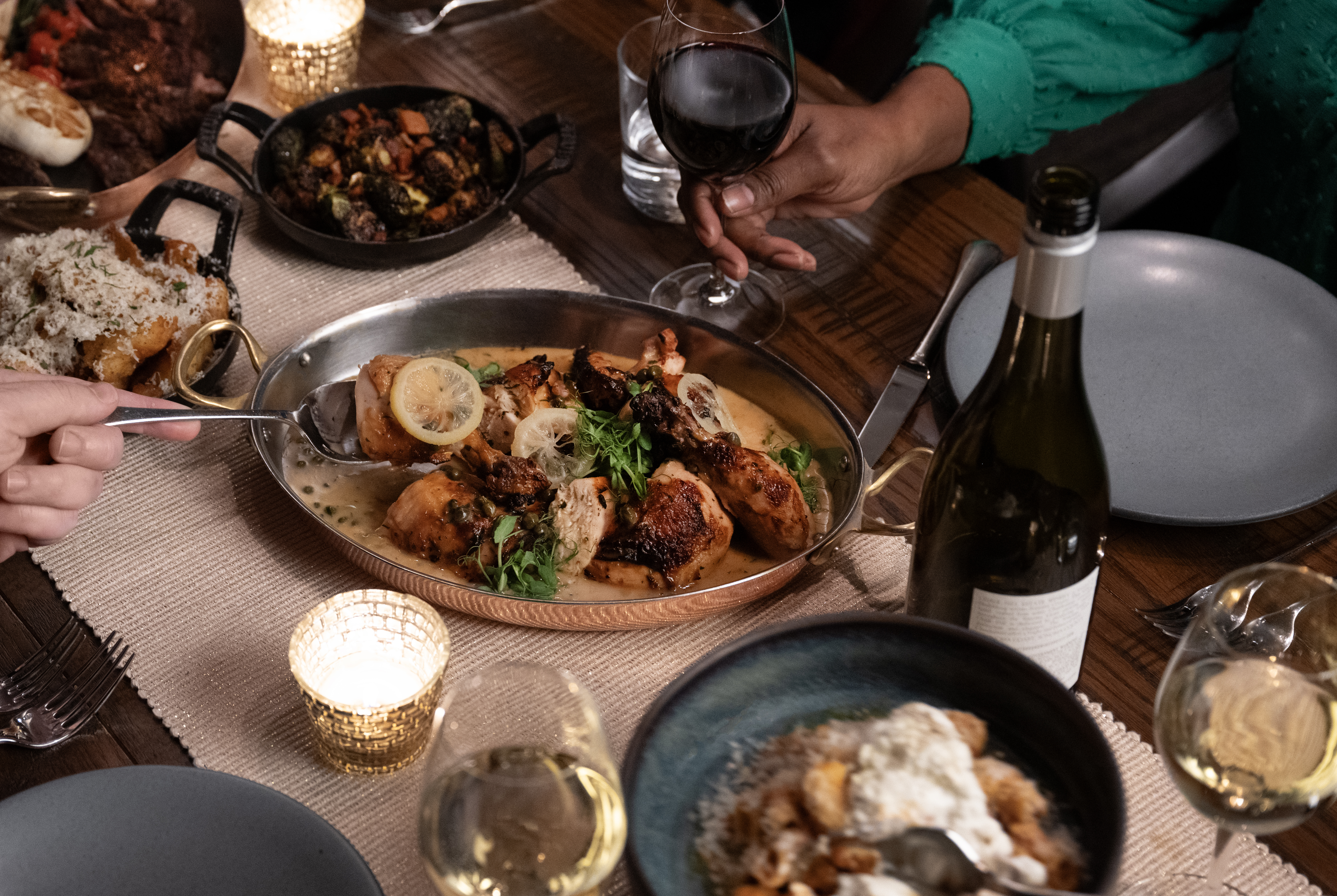 a group of people sitting at a table with a plate of food
