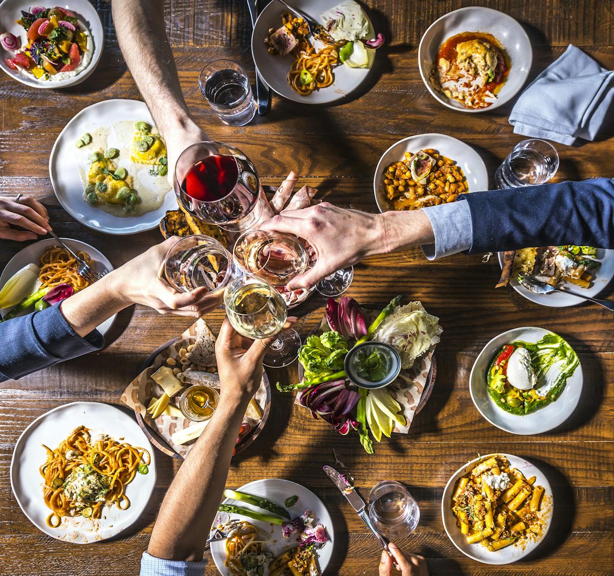 an overview of a table filled with multiple plates of food