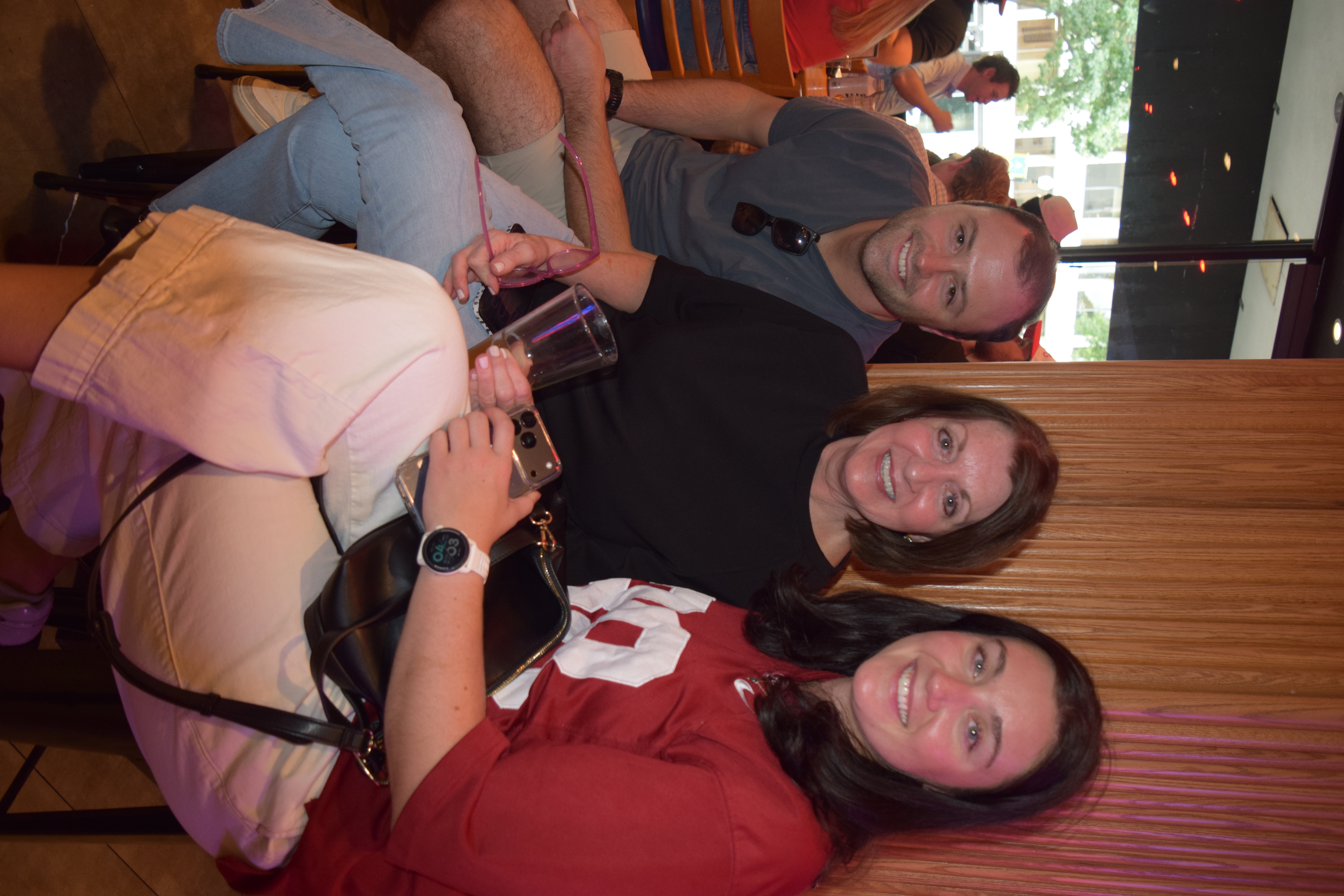 a group of people sitting together smiling