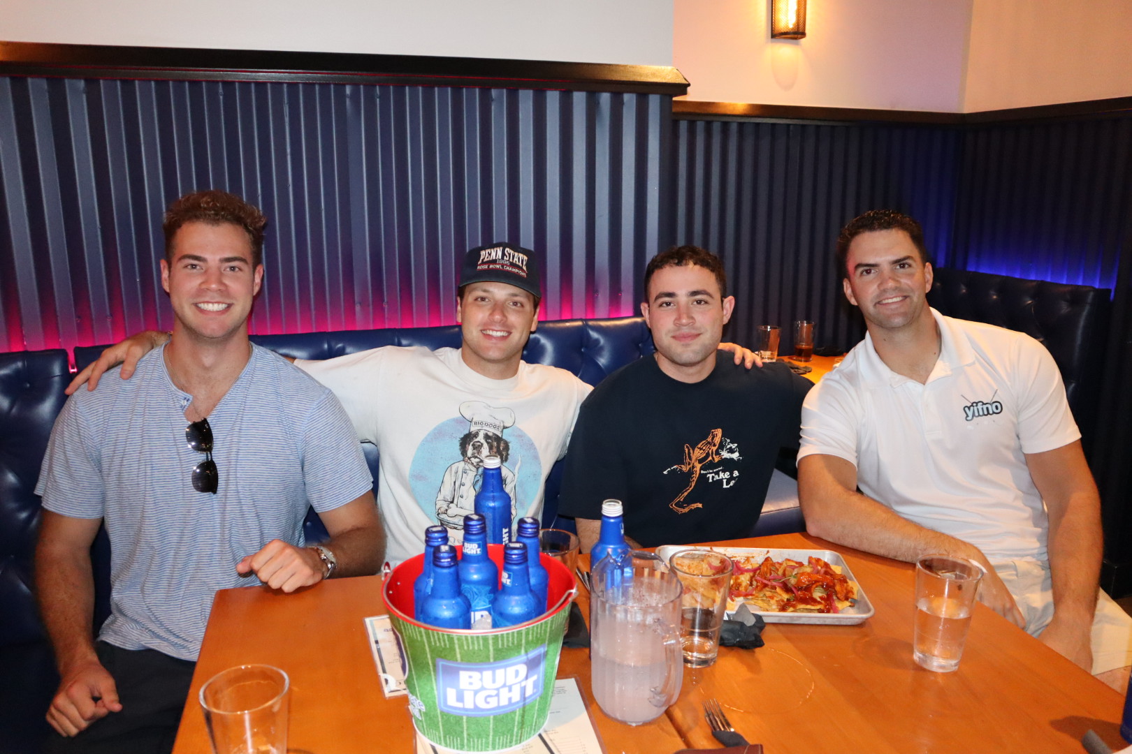 a group of people sitting at a table with wine glasses
