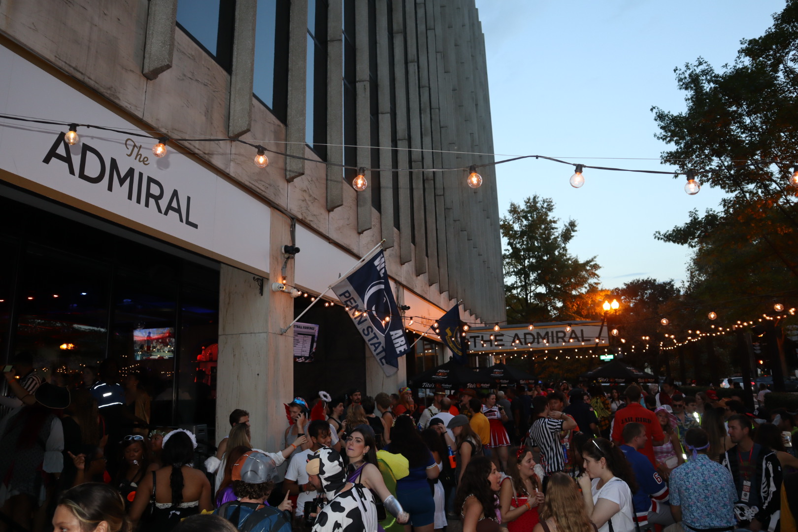 a crowd of people walking down a street