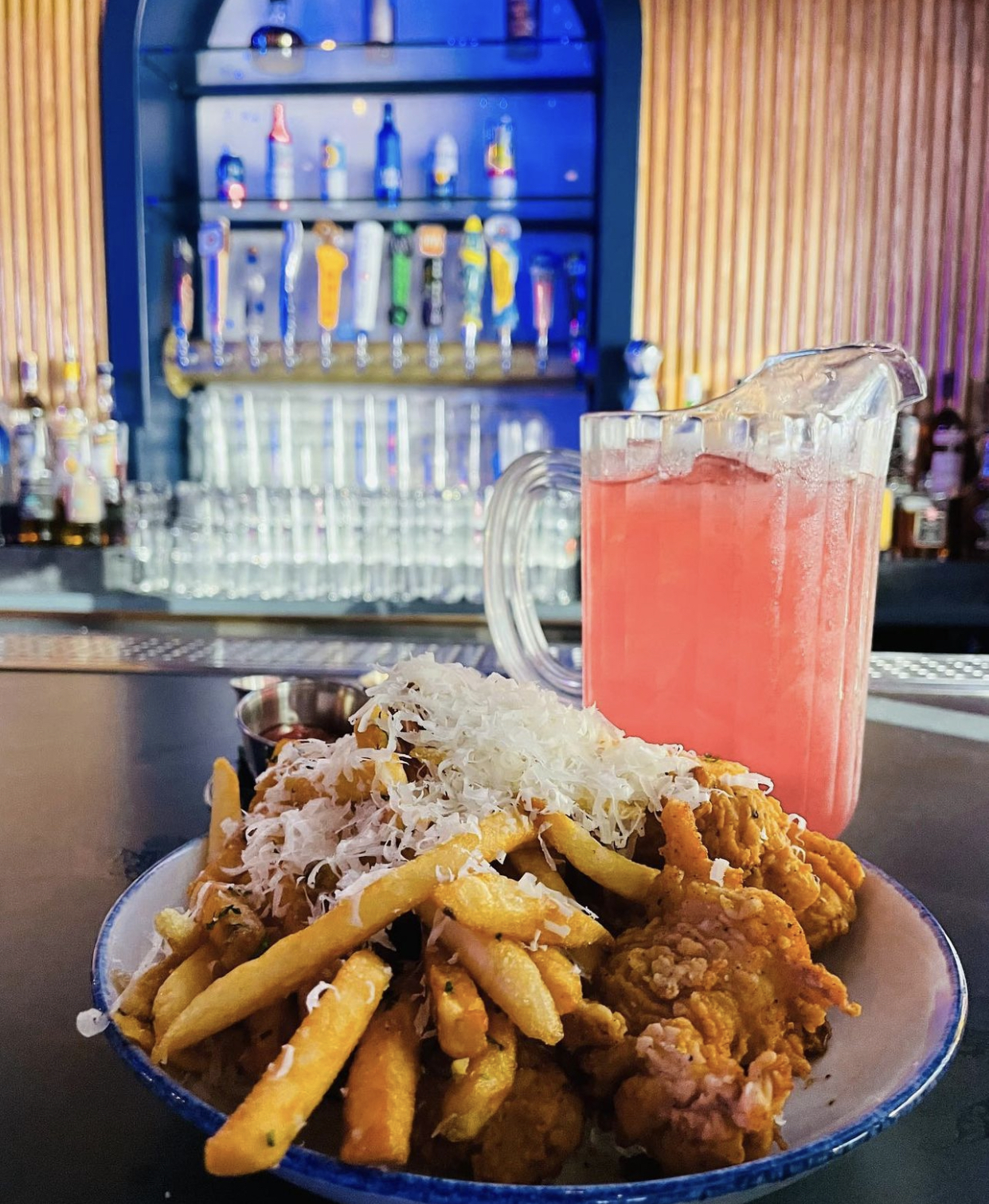 a plate of food with a glass of beer on a table