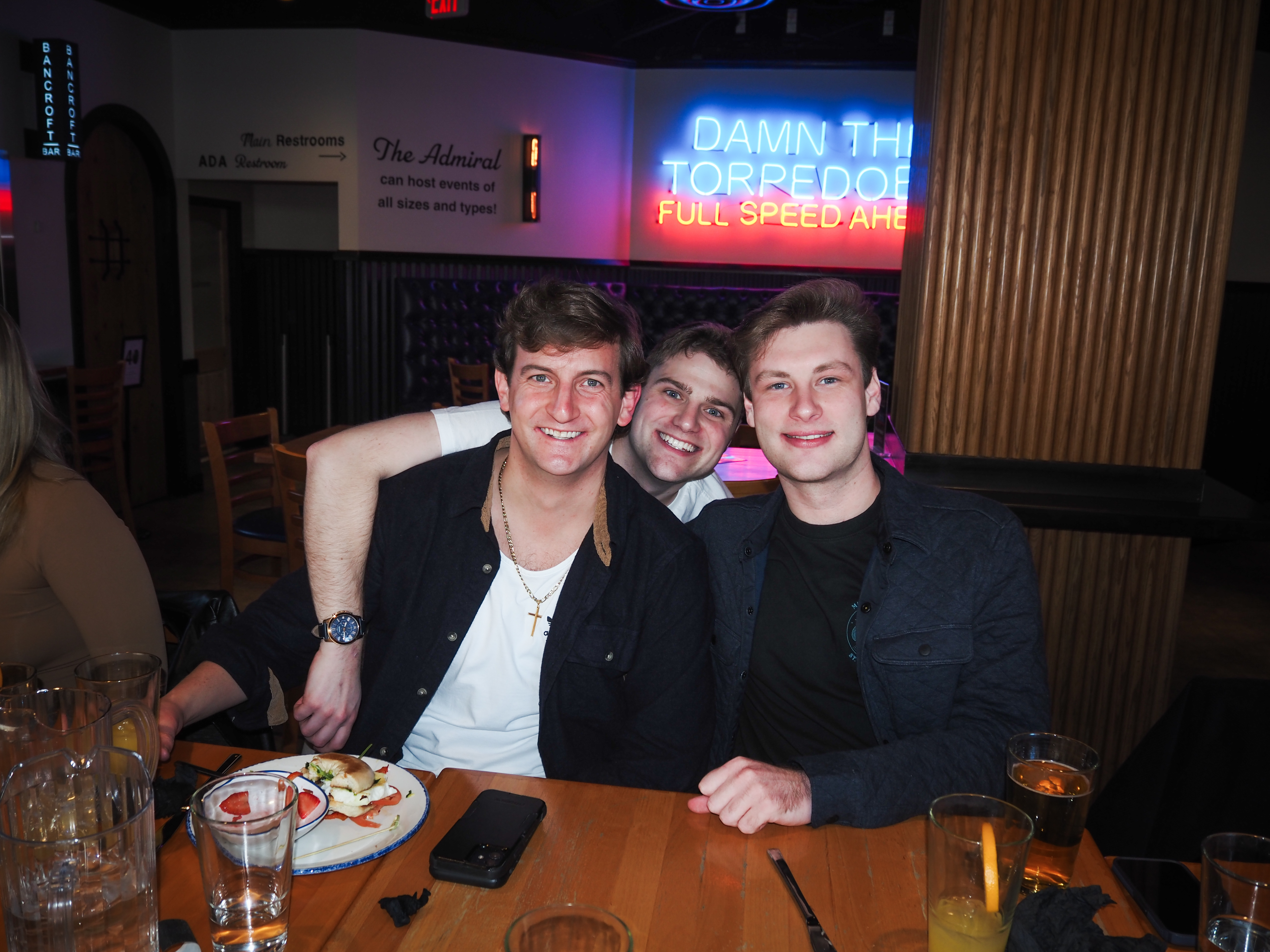 a group of people sitting at a table in a restaurant