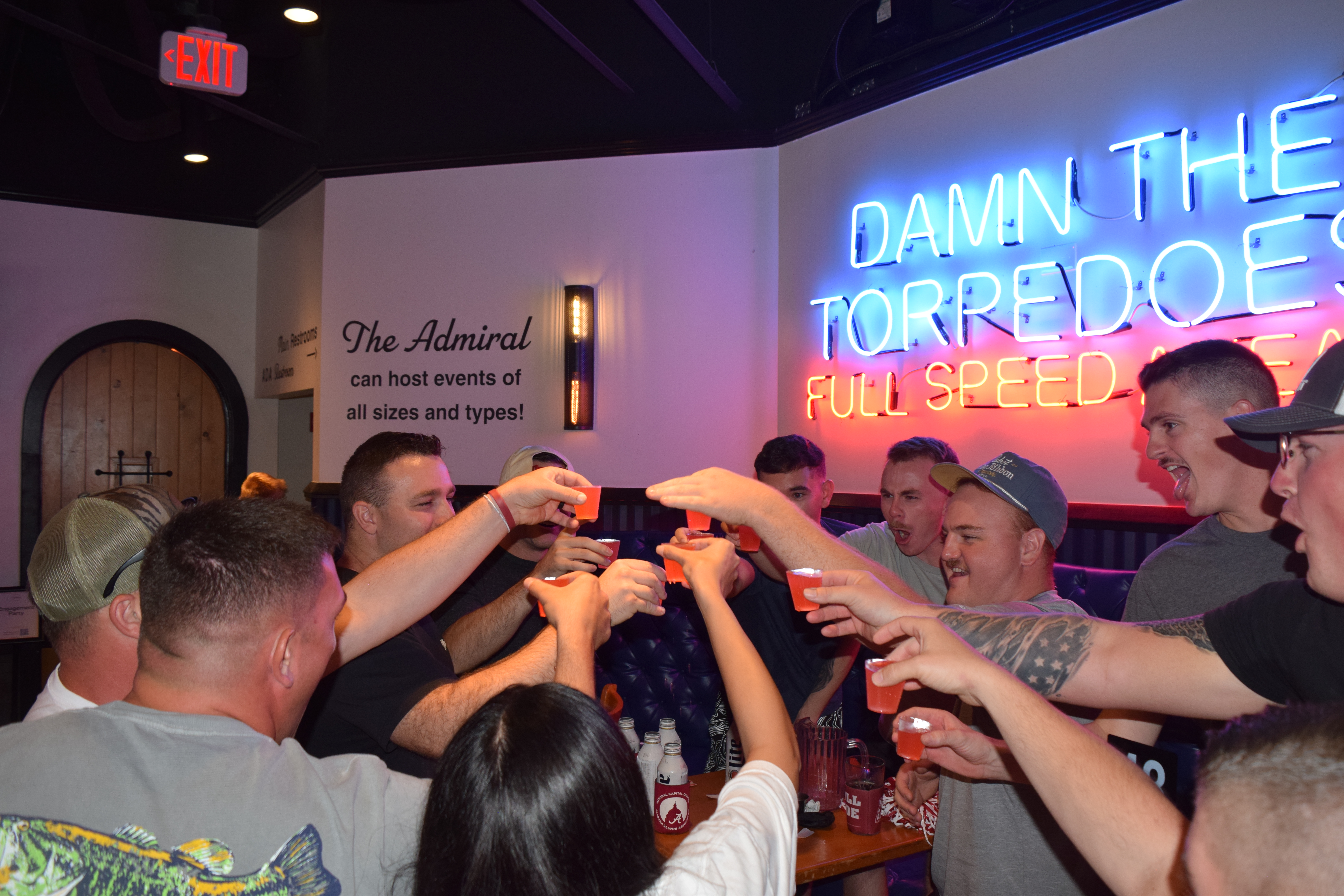 a group of people holding up drinks