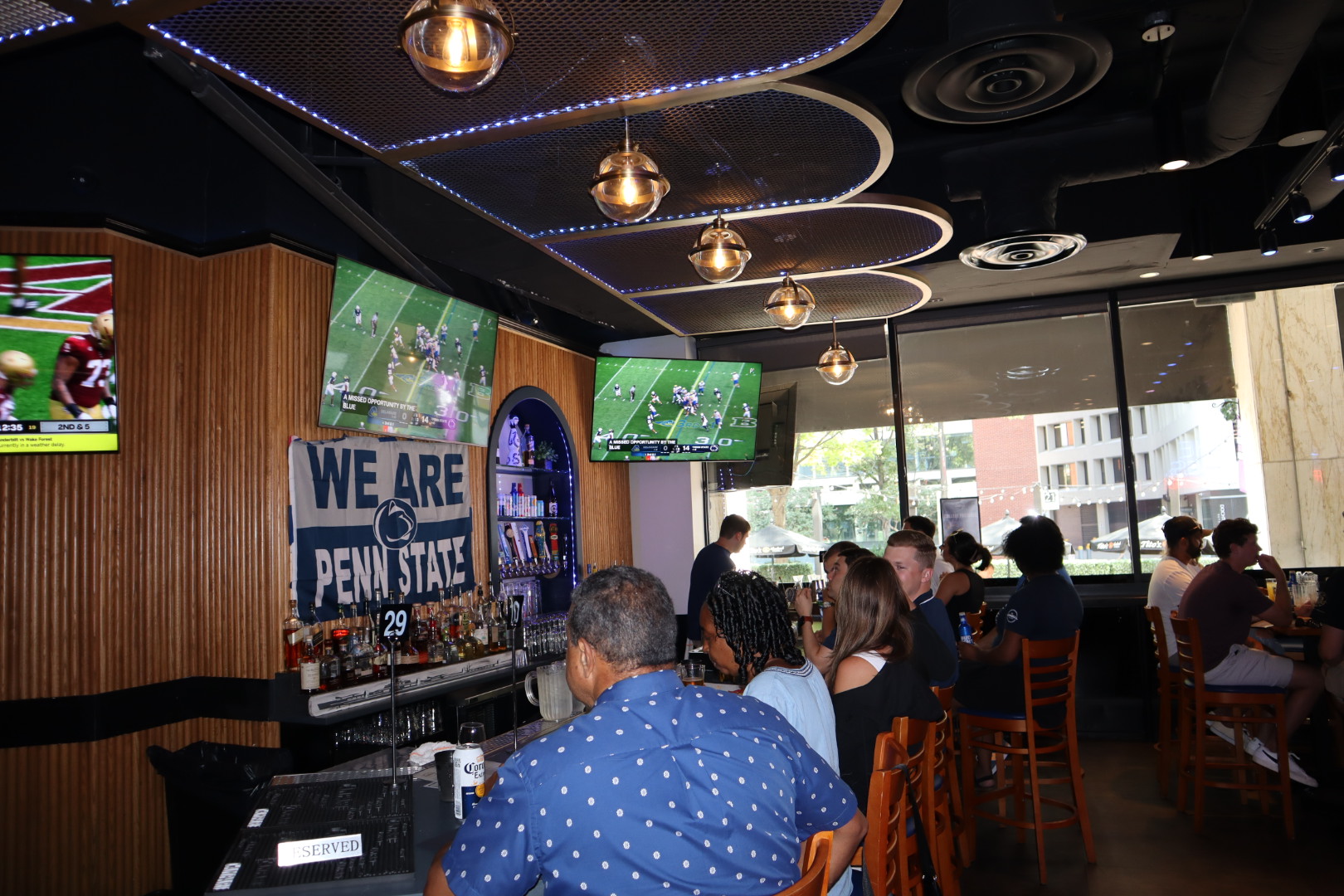 a group of people sitting at a table in a restaurant
