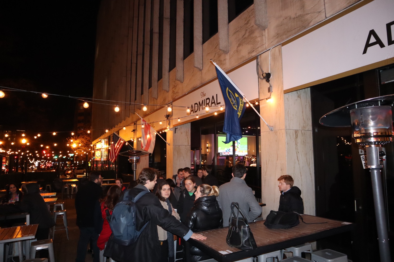 a group of people sitting at a table with wine glasses