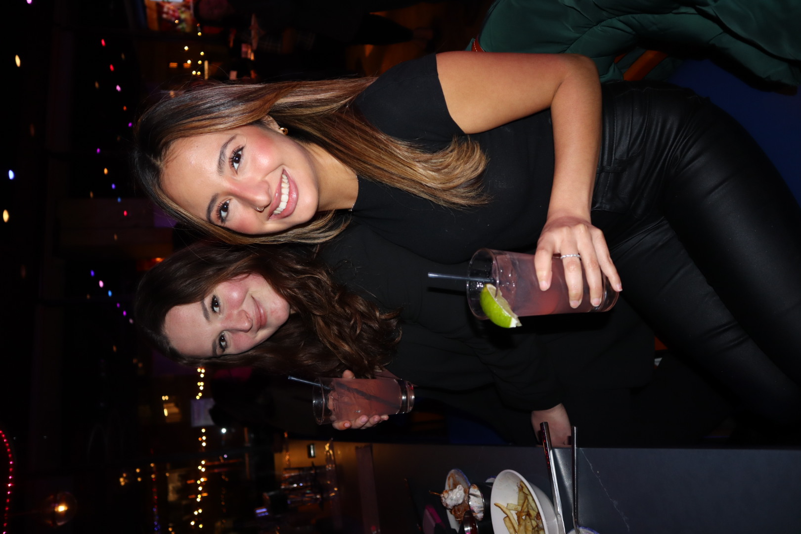 Phoebe Sparrow sitting at a table posing for the camera