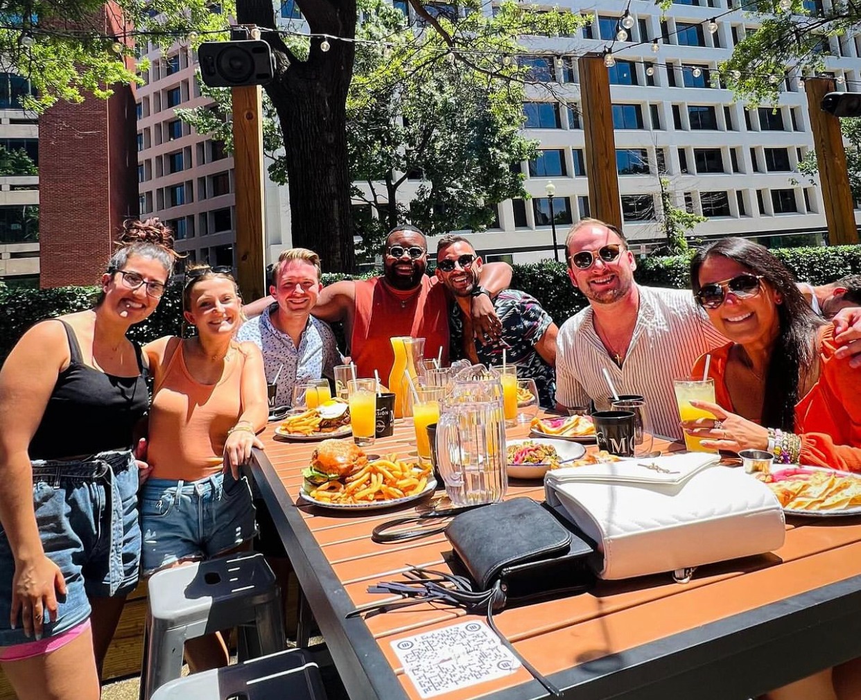 a group of people sitting at a picnic table