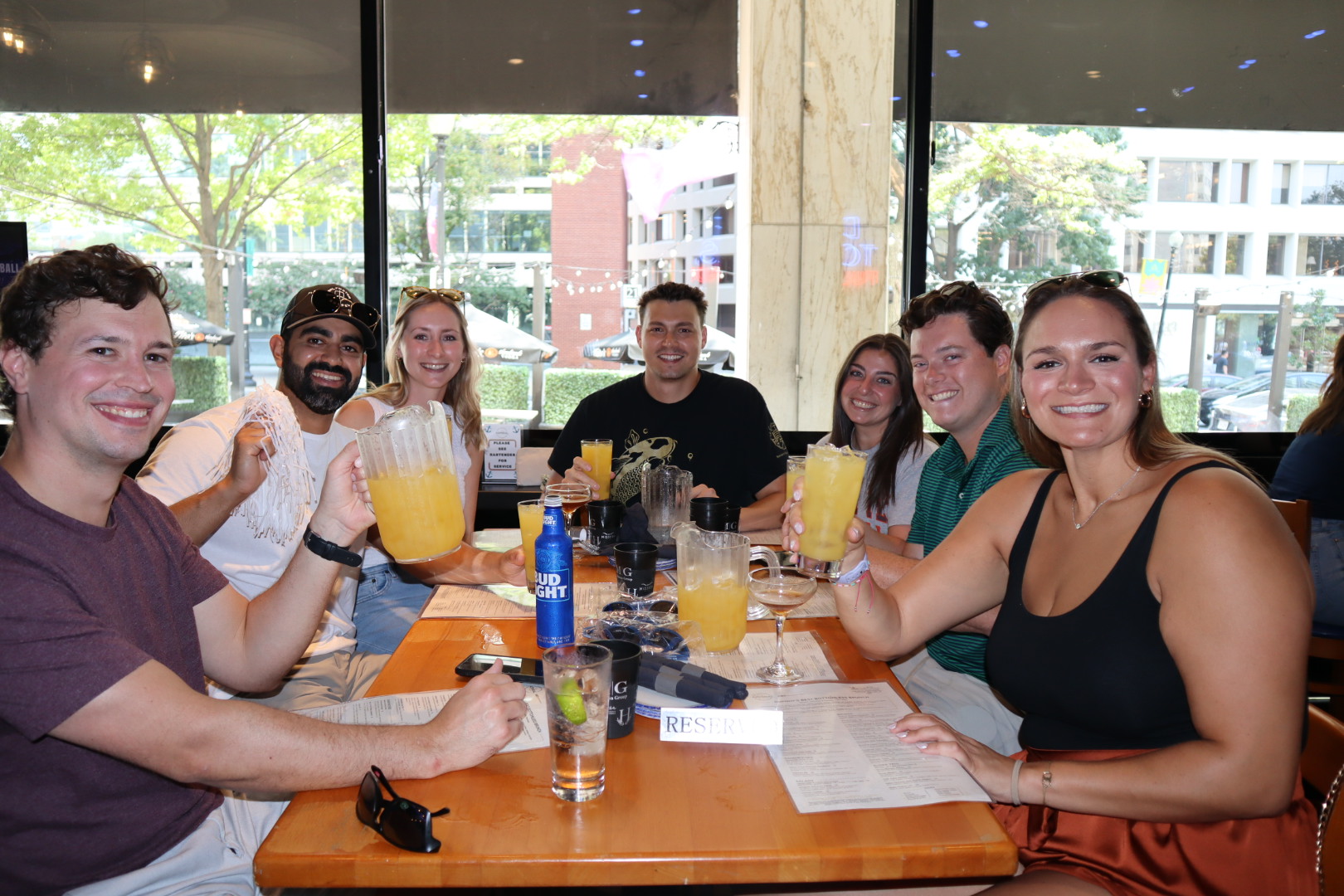 a group of people sitting at a table with wine glasses