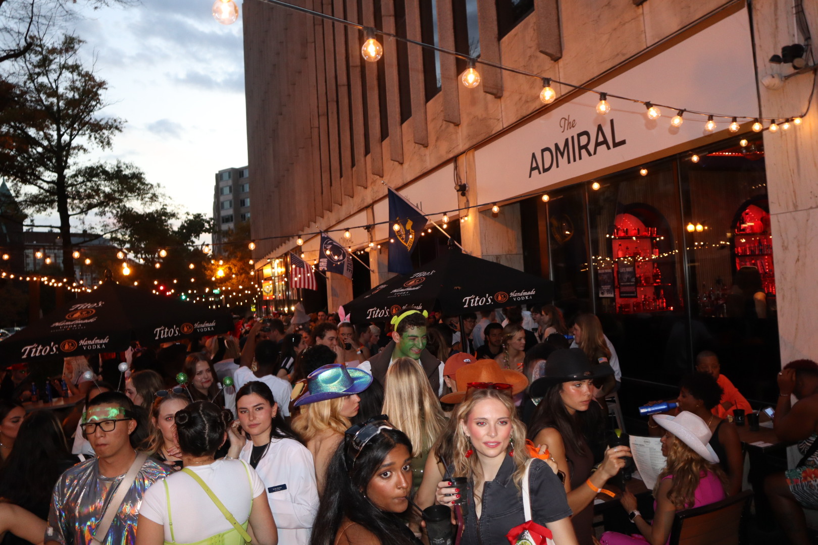 a group of people standing in front of a crowd posing for the camera