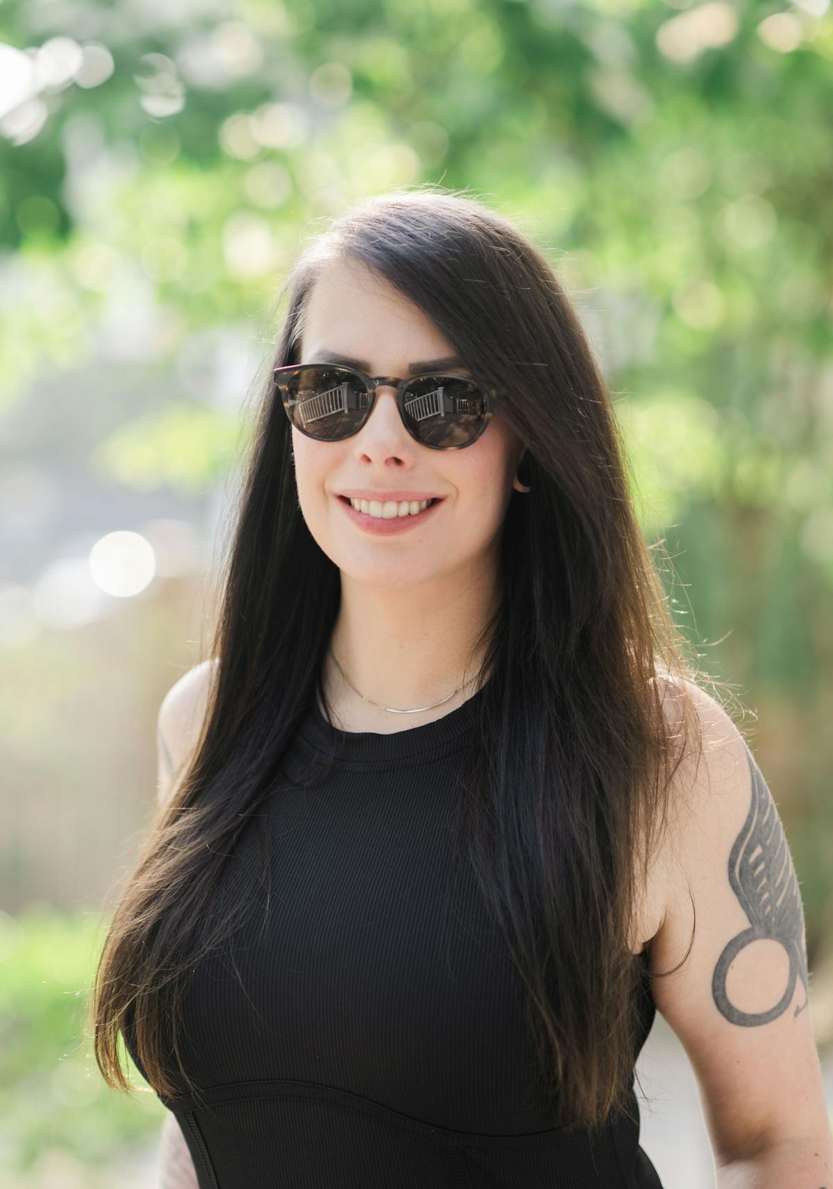 a woman wearing sunglasses posing for the camera