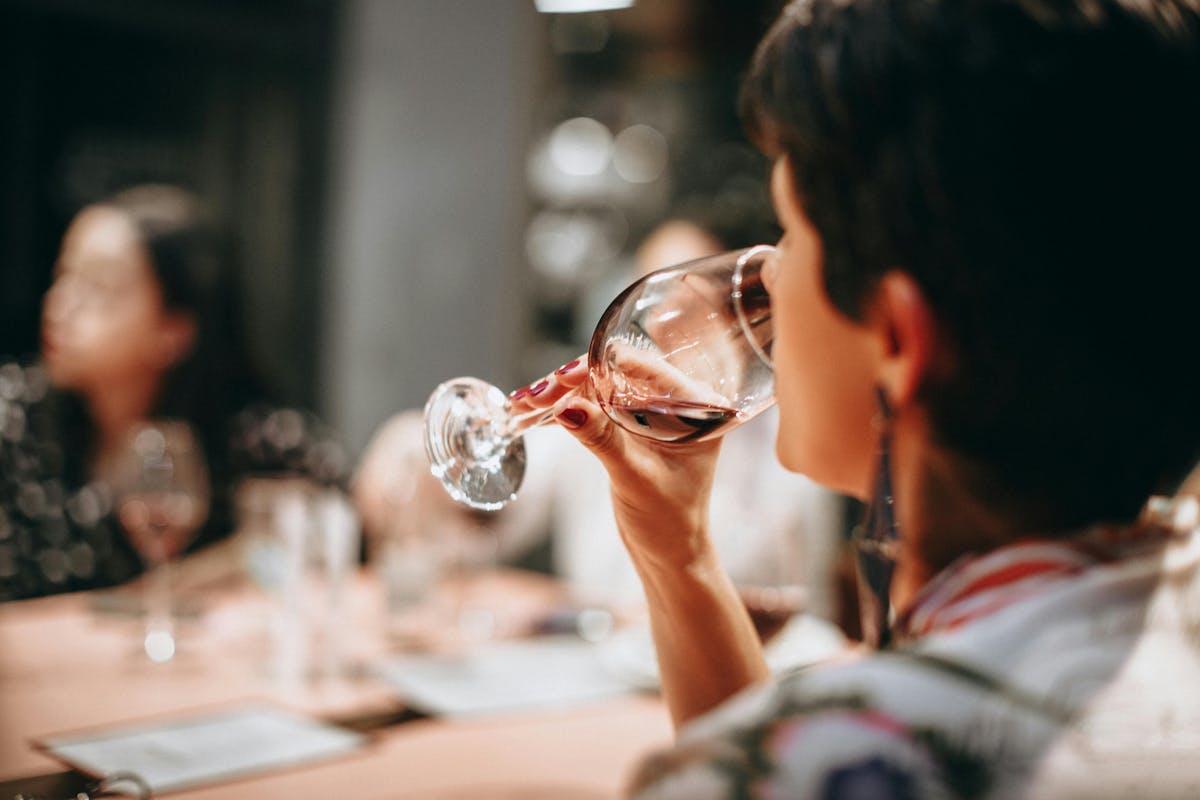 a person drinking wine