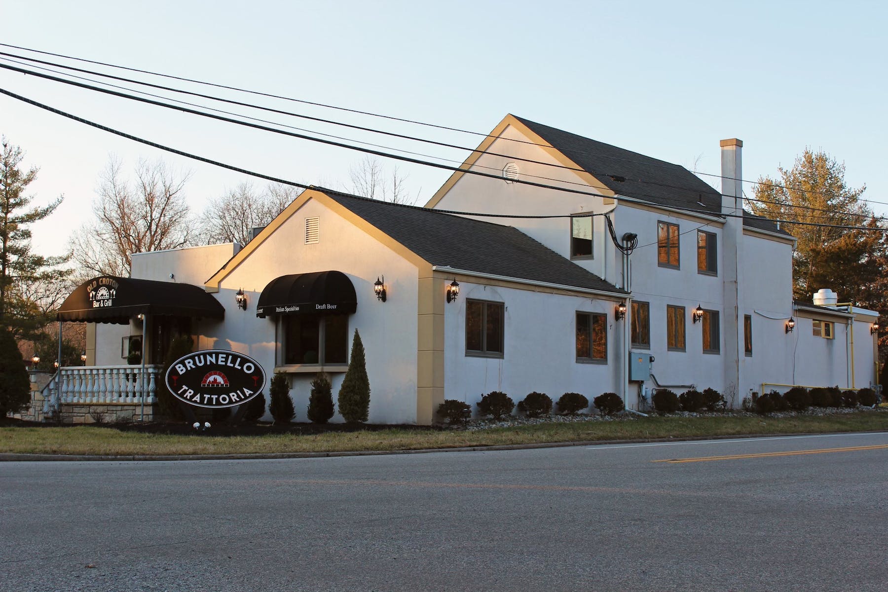 a house that has a sign on the side of a road