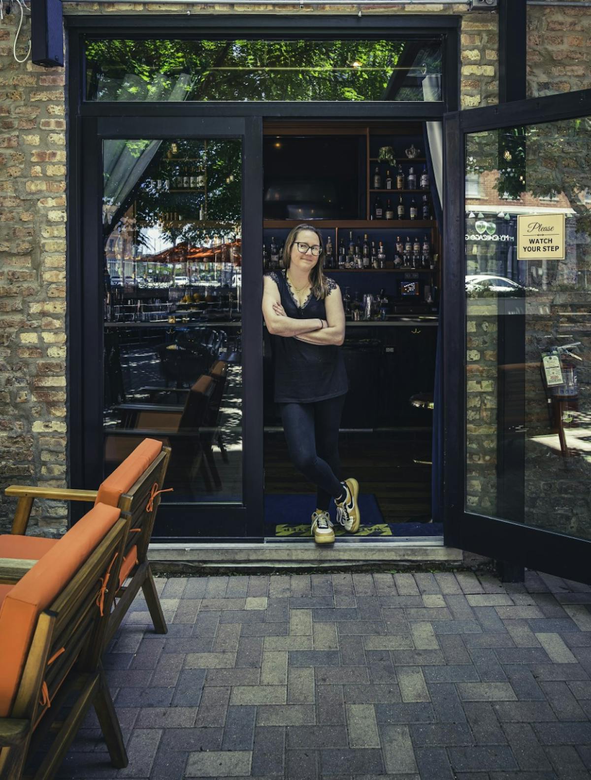 a person sitting on a bench in front of a store