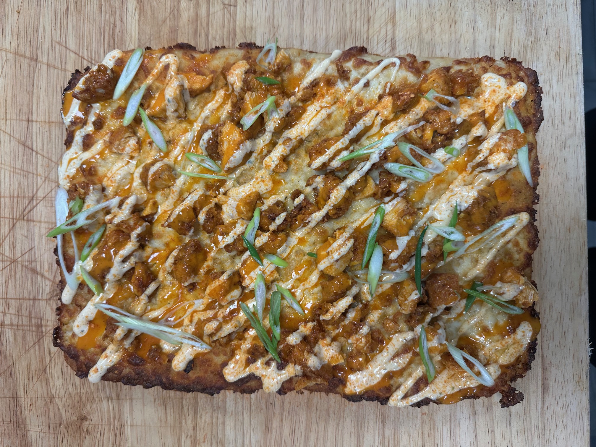 a slice of pizza sitting on top of a wooden cutting board