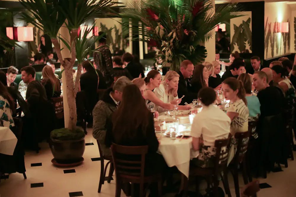 a group of people sitting at a table with wine glasses