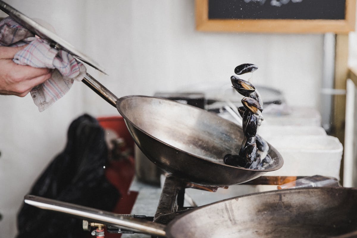 a close up of a person cutting a piece of metal pan
