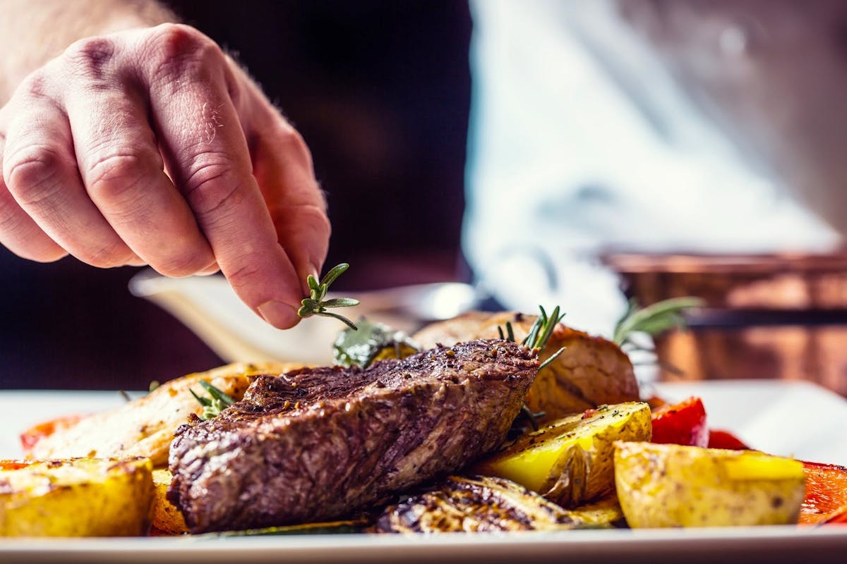 a close up of a person holding a plate of food
