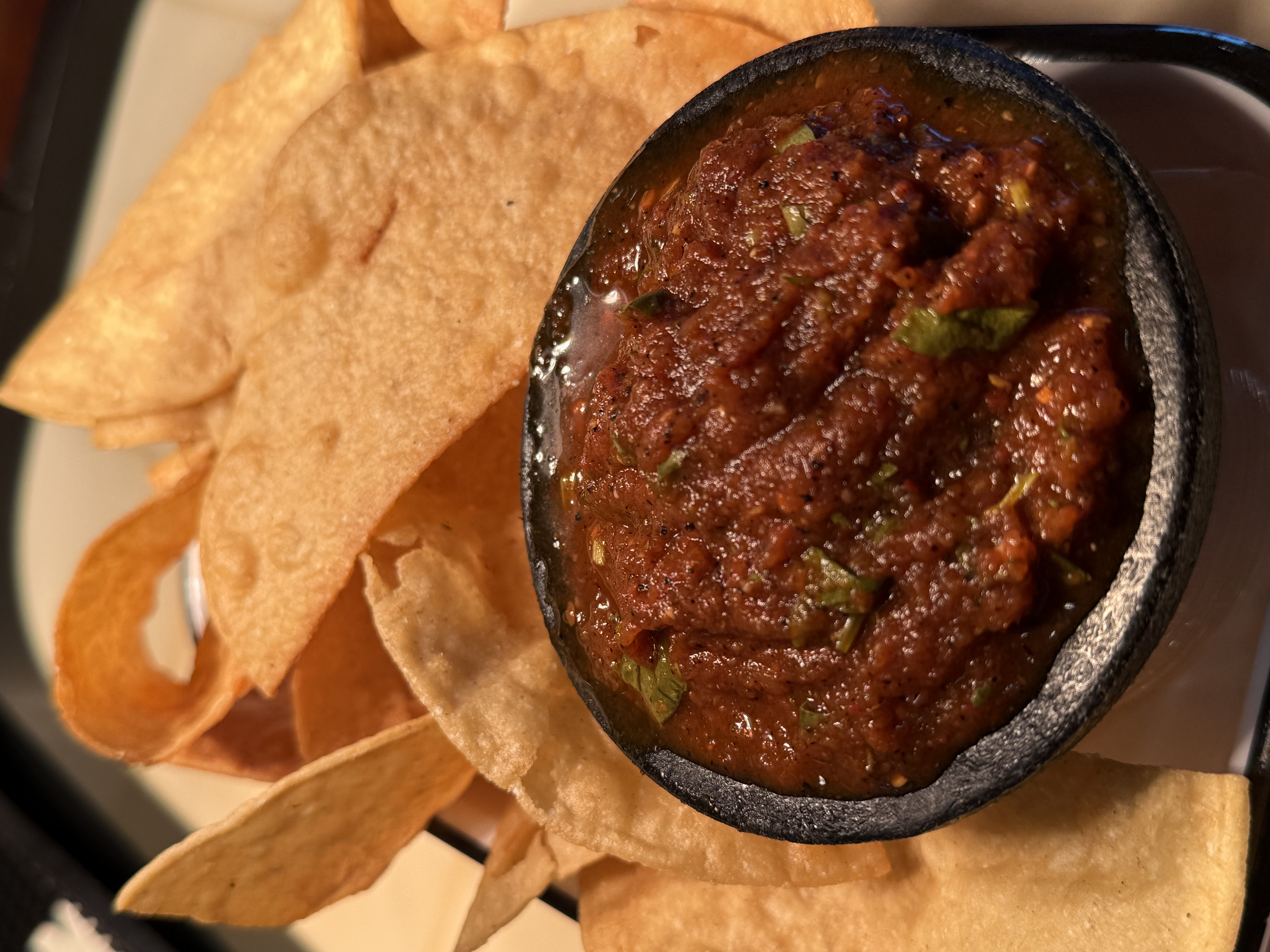 a bowl of salsa and chips