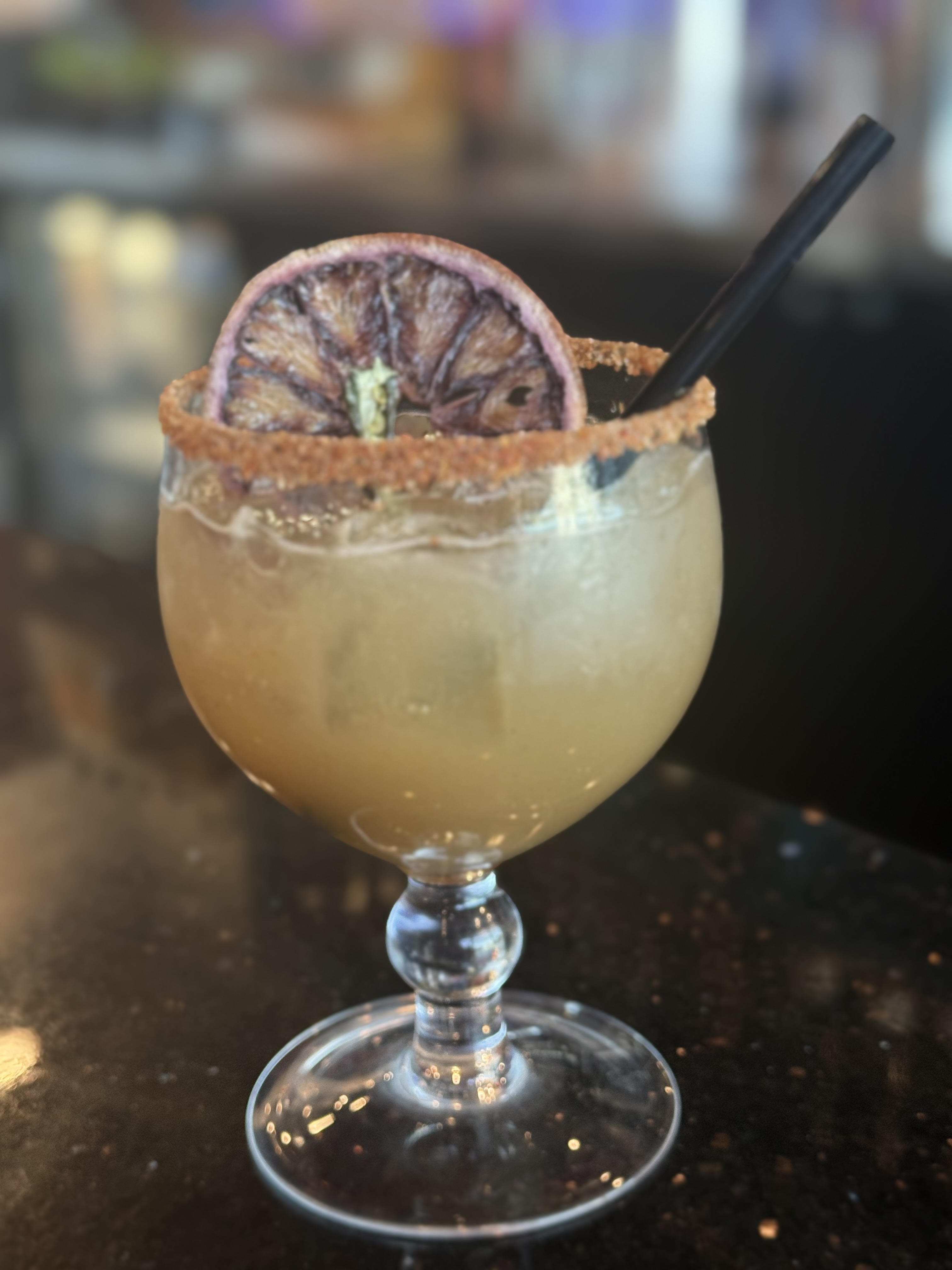 a glass with a drink and a straw