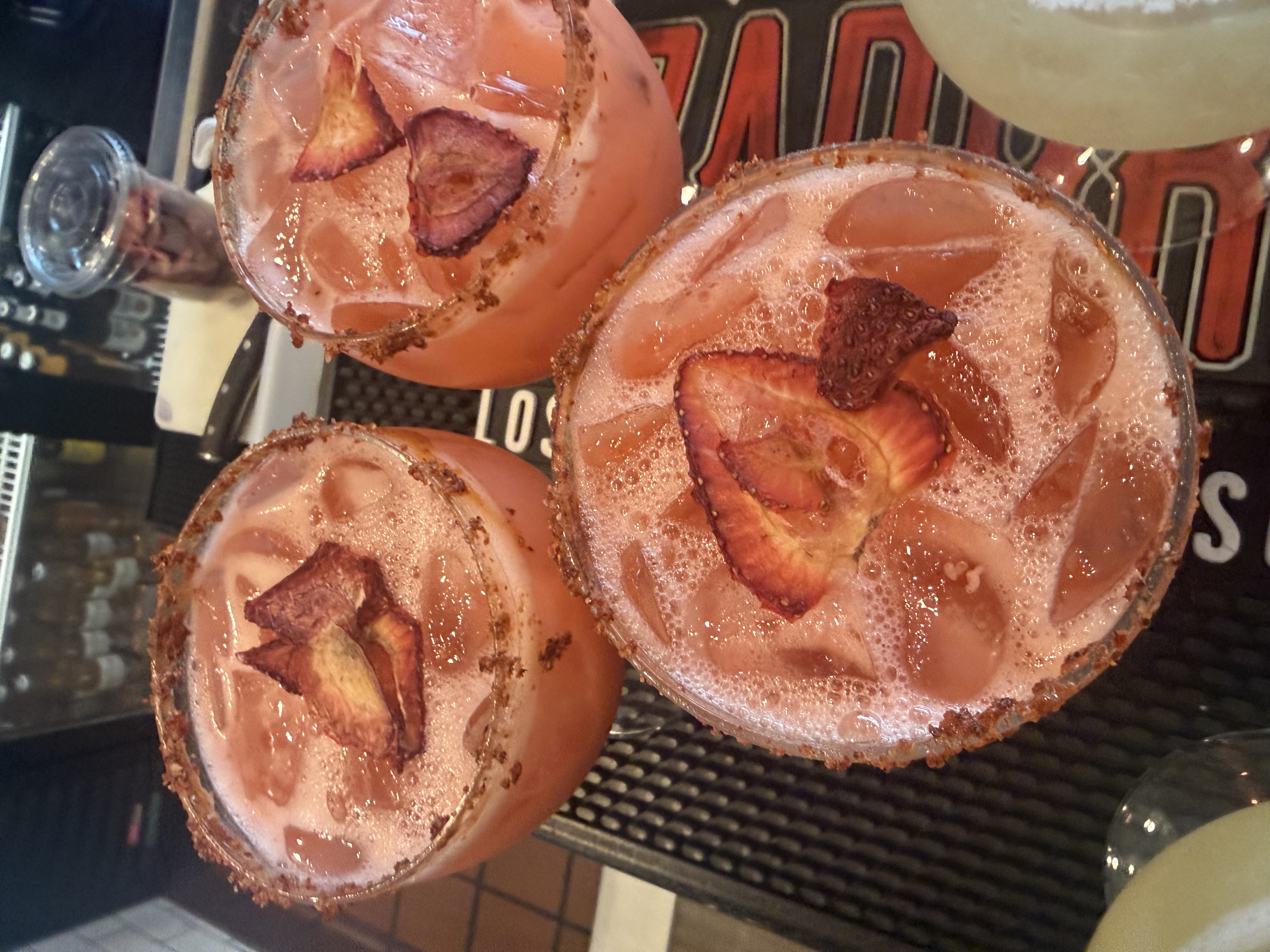 a group of glasses with drinks