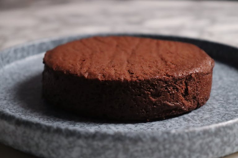 a close up of a piece of chocolate cake on a plate