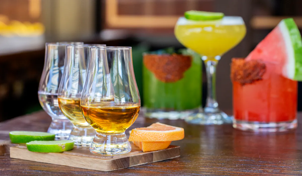 a glass of wine sitting on top of a wooden table