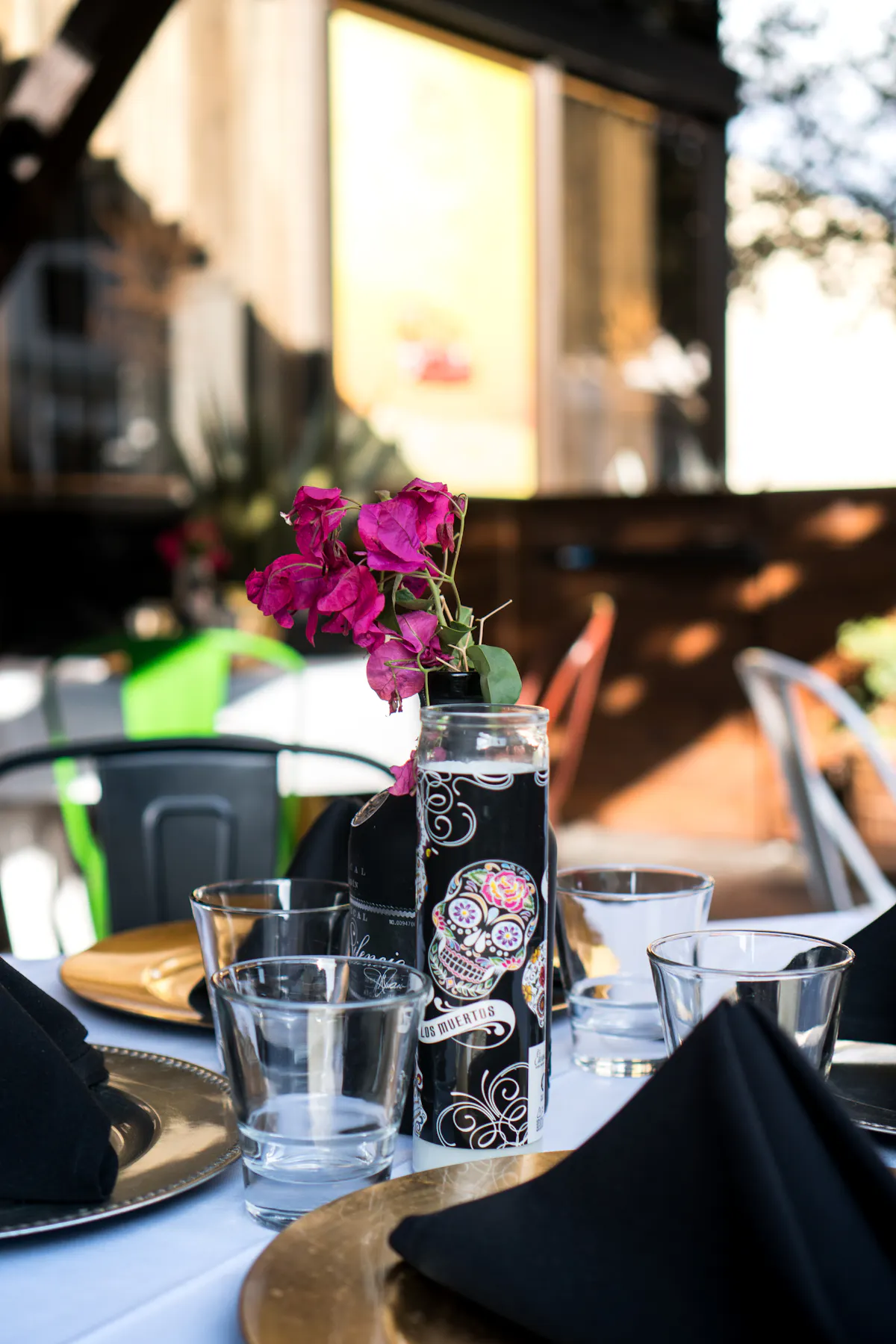 a person sitting at a table with a vase of flowers