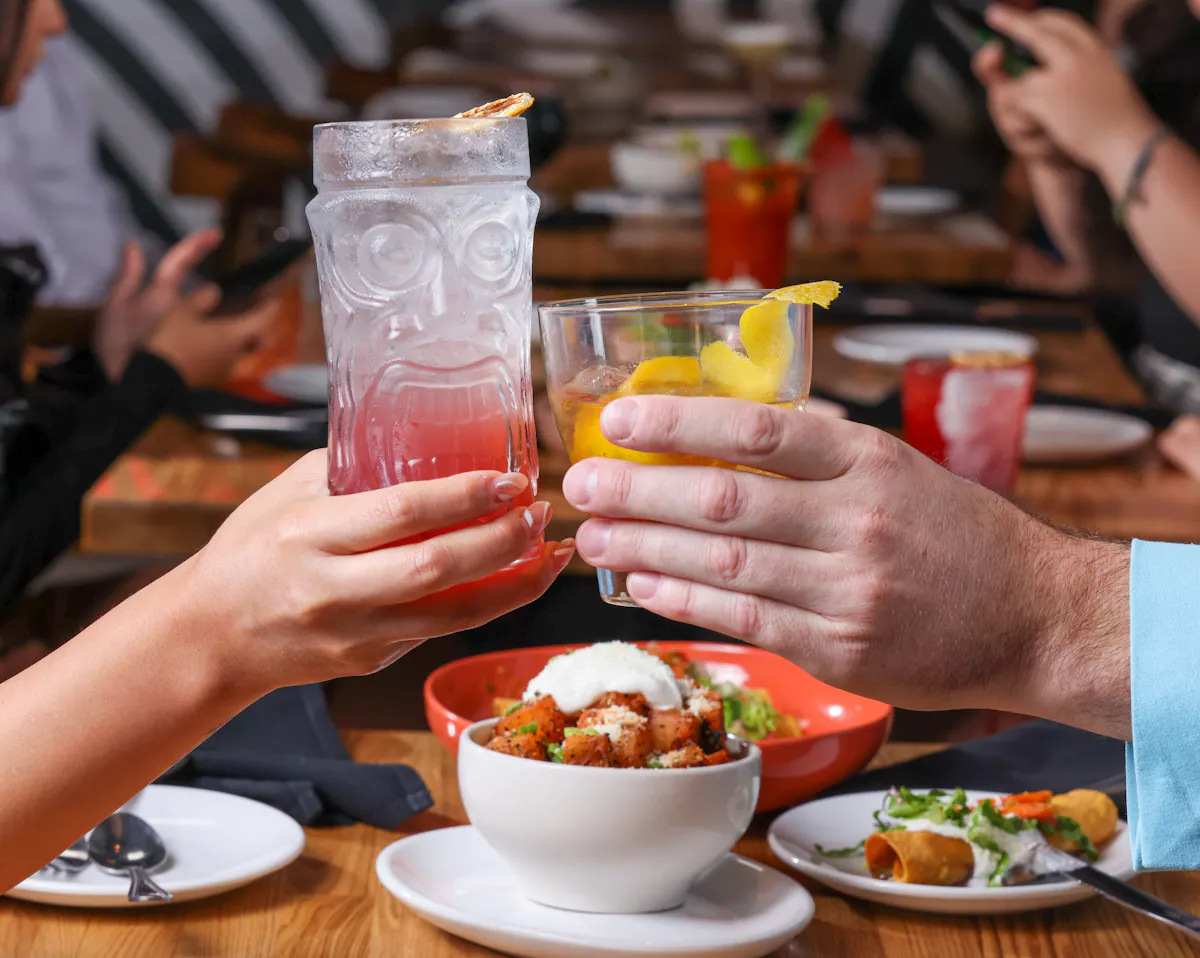 a person sitting at a table with a plate of food