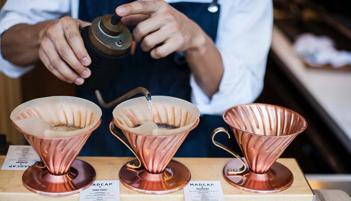 a person holding a cup of coffee