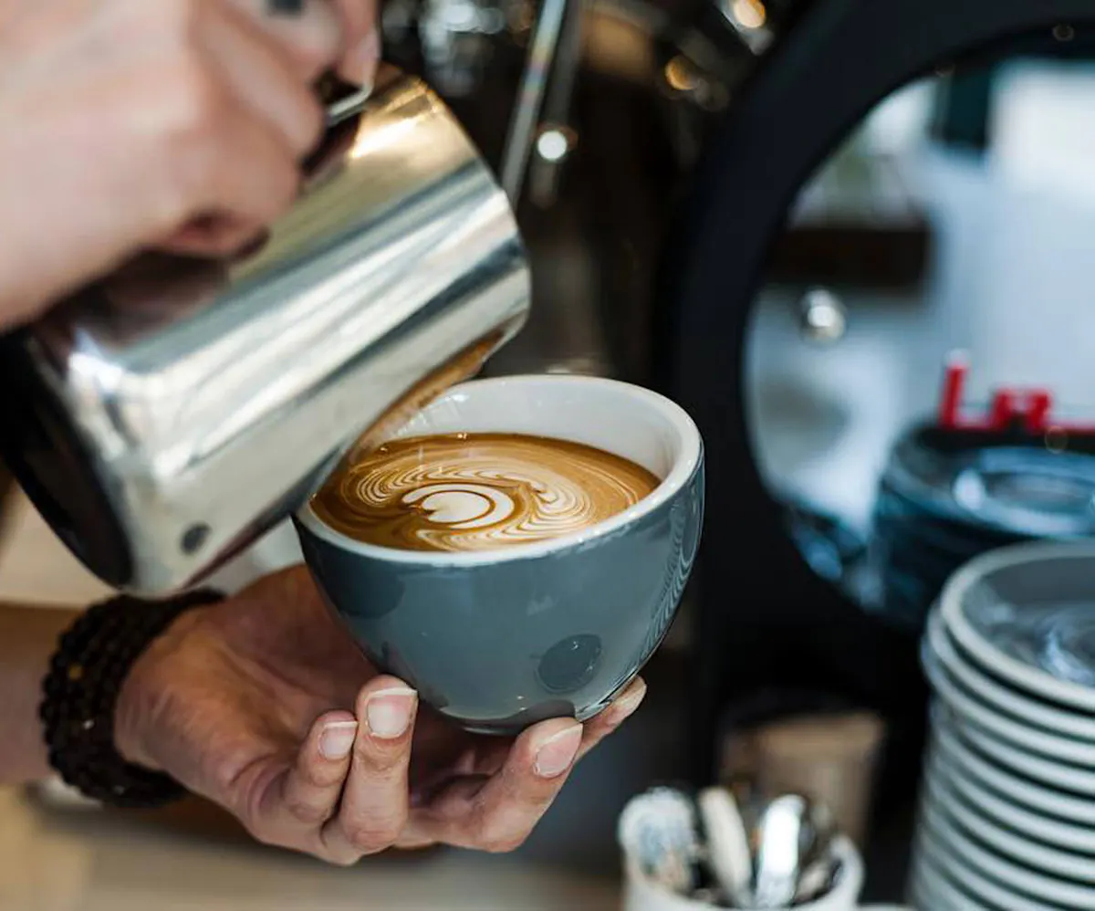 a person holding a cup of coffee