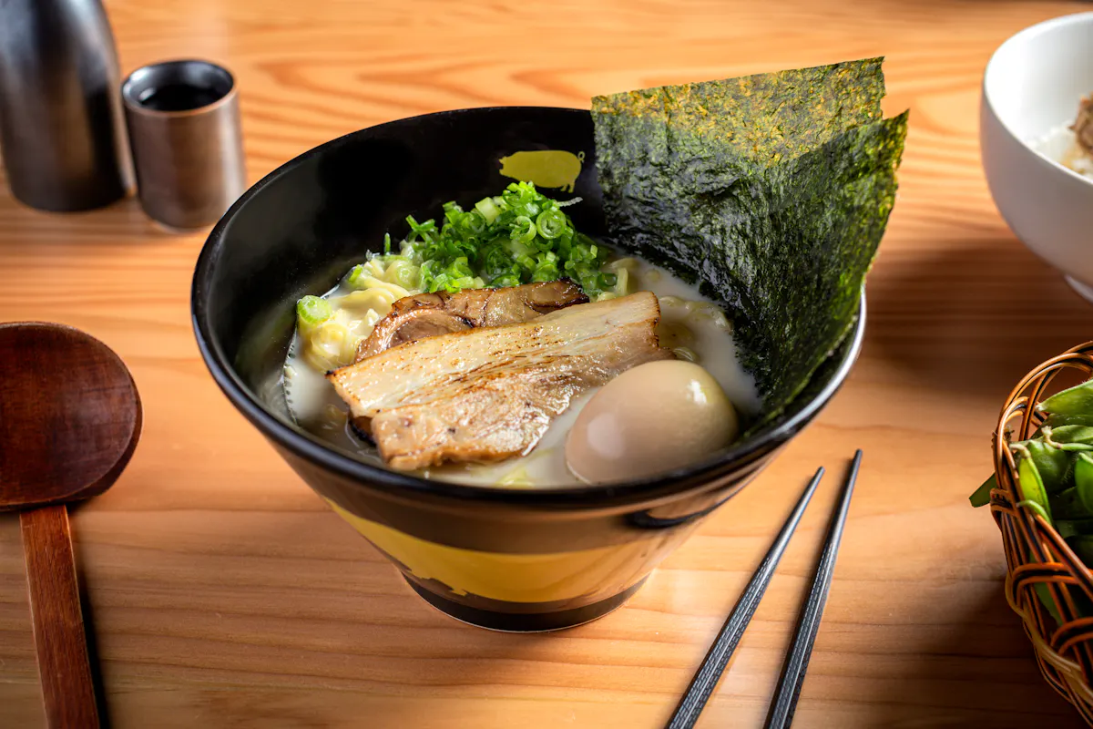 a bowl of food sitting on top of a wooden table