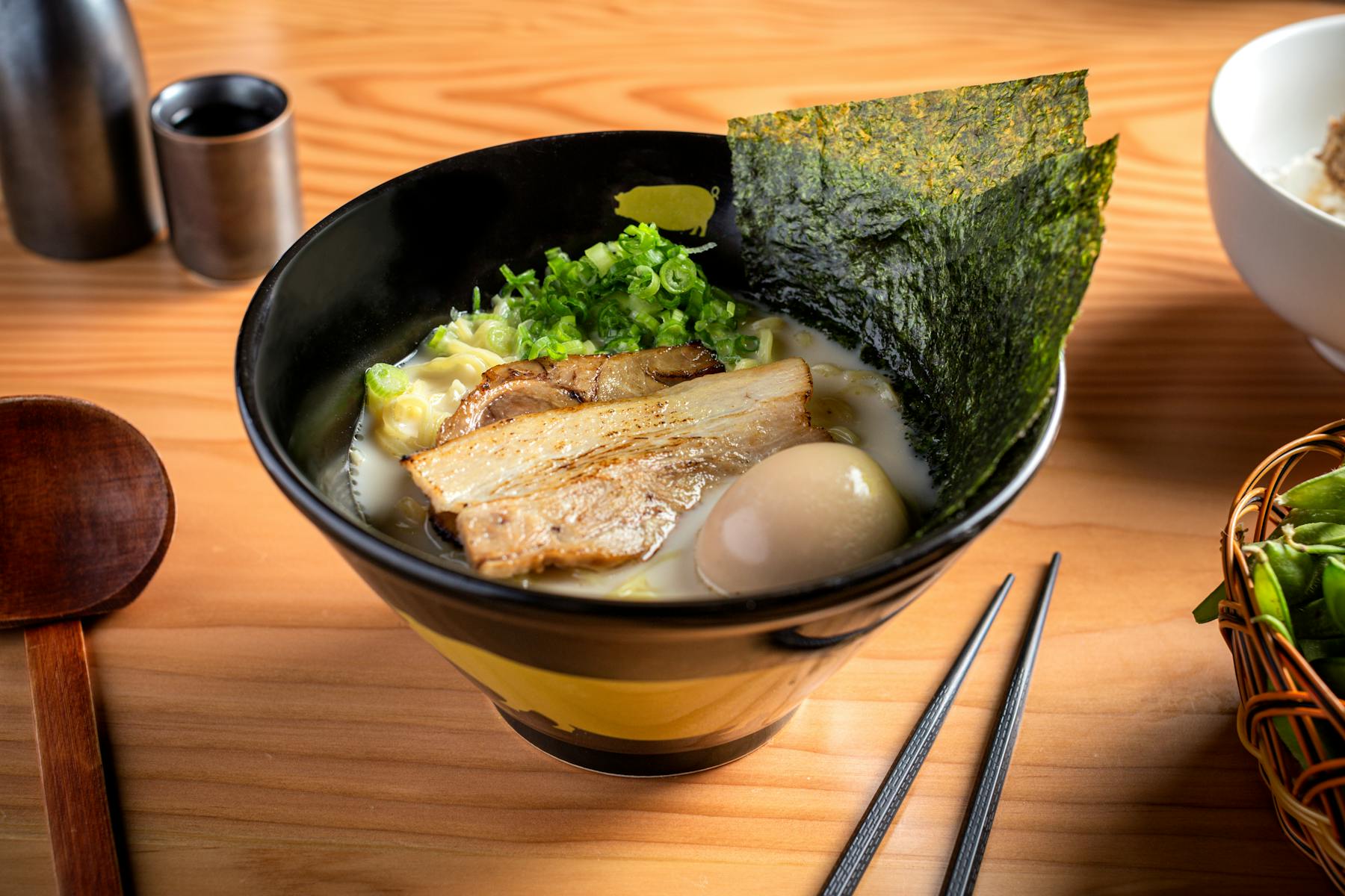 a bowl of food sitting on top of a wooden table