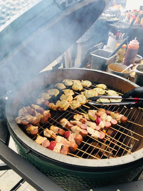 a group of meat cooking on a grill