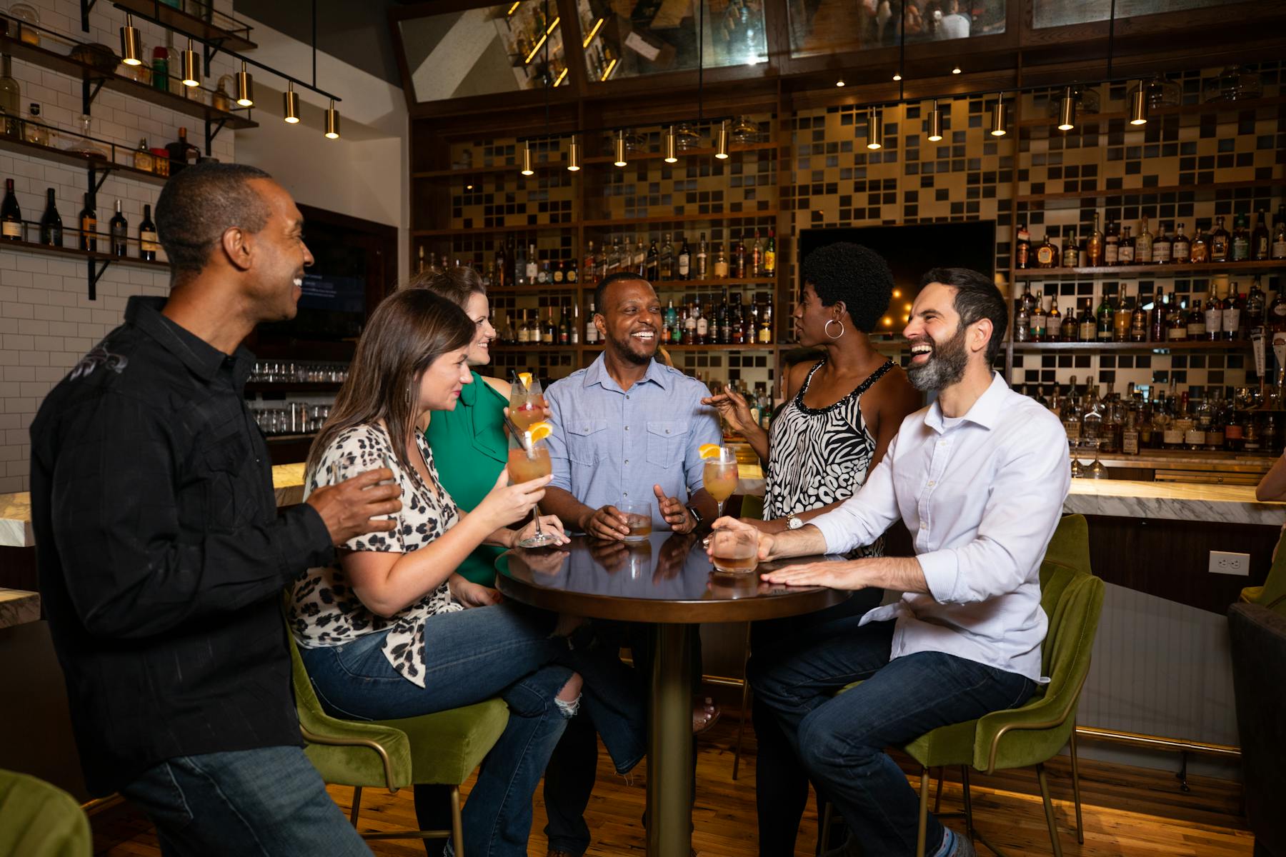 a group of people sitting at a table with wine glasses