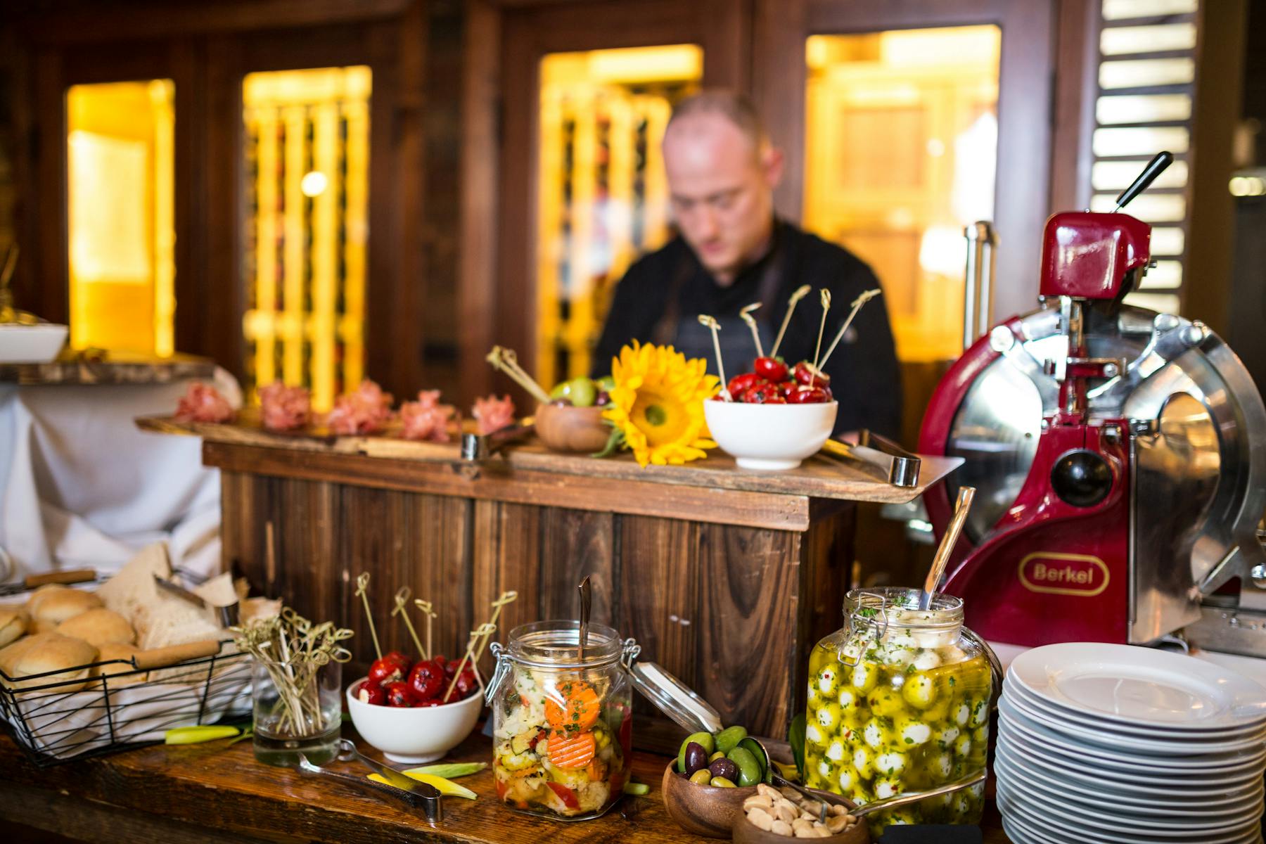a group of people sitting at a table with food and drinks