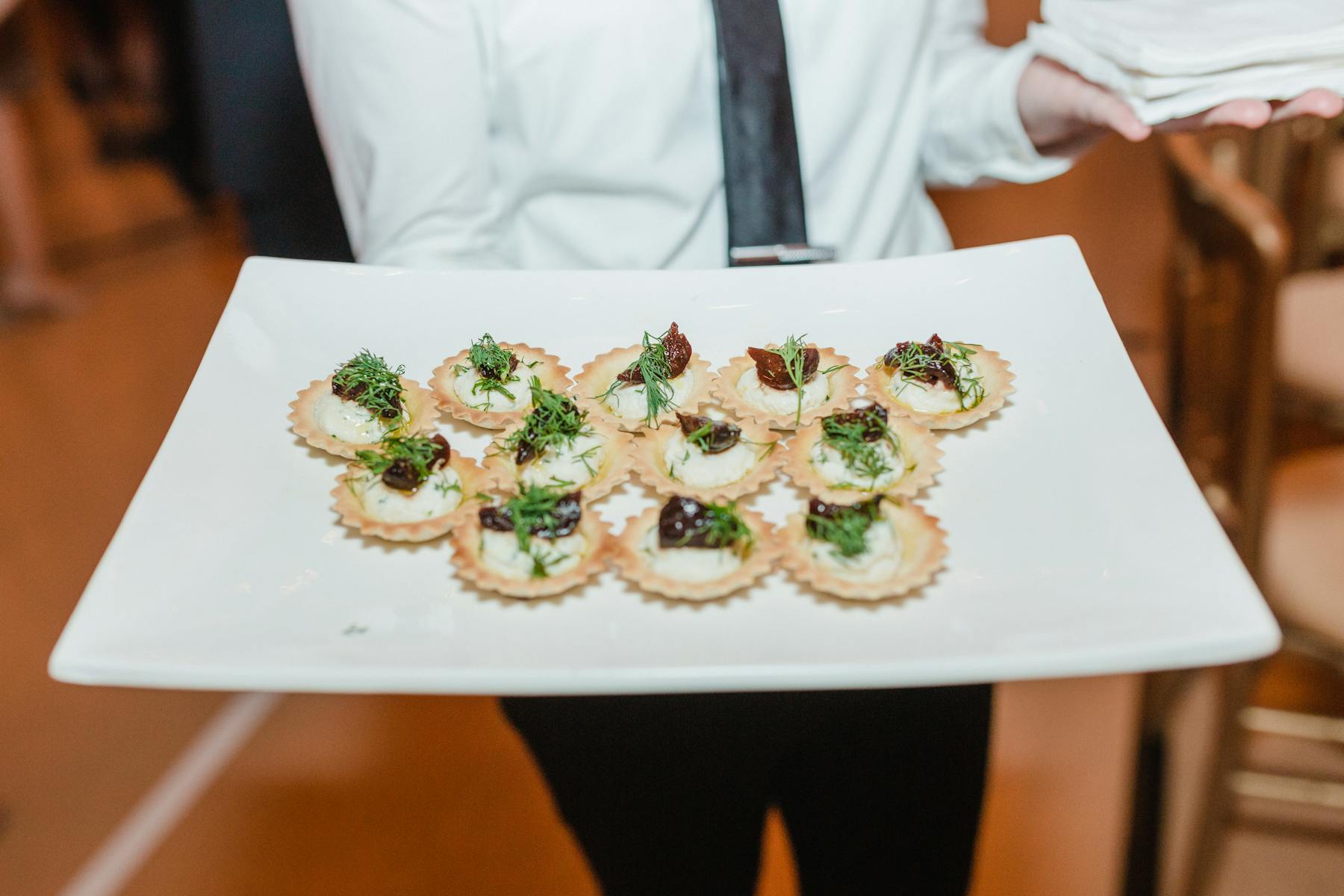 a person sitting at a table with a plate of food