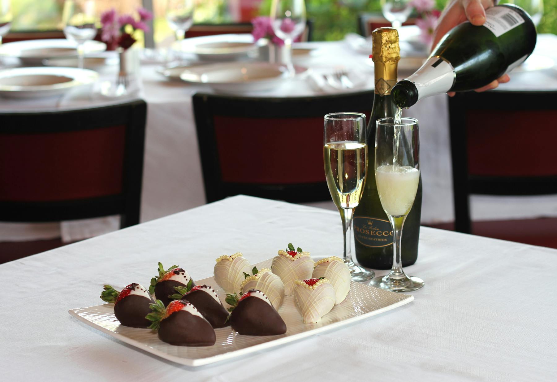 a plate of food and glasses of wine sitting on top of a table