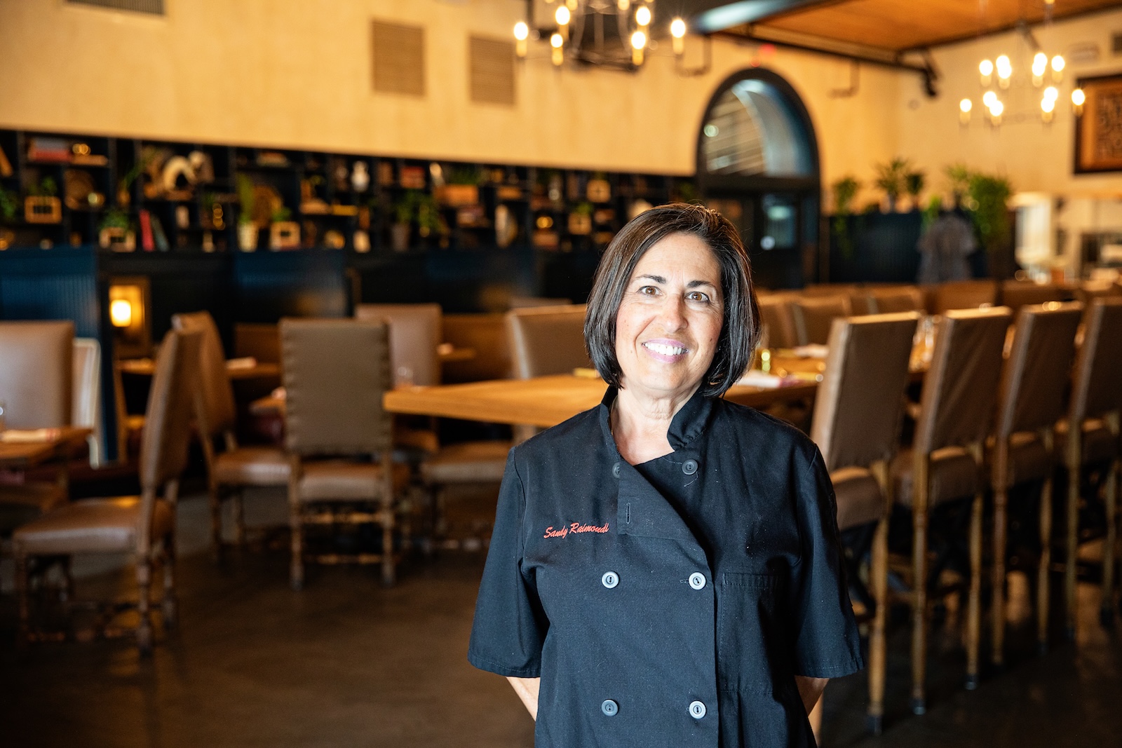 a woman standing in front of a restaurant