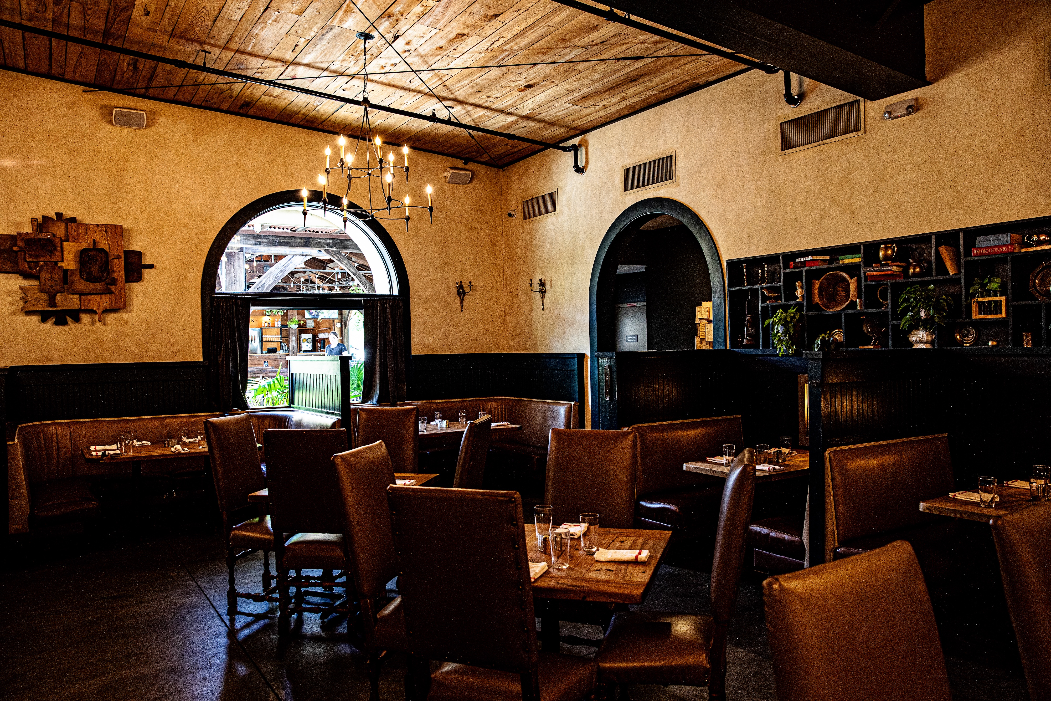 a living room filled with furniture and a table in a restaurant