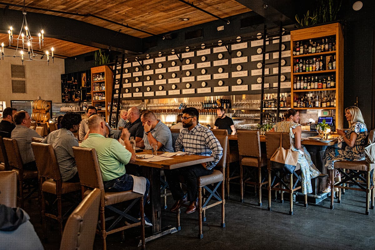 a group of people sitting at a table in a restaurant