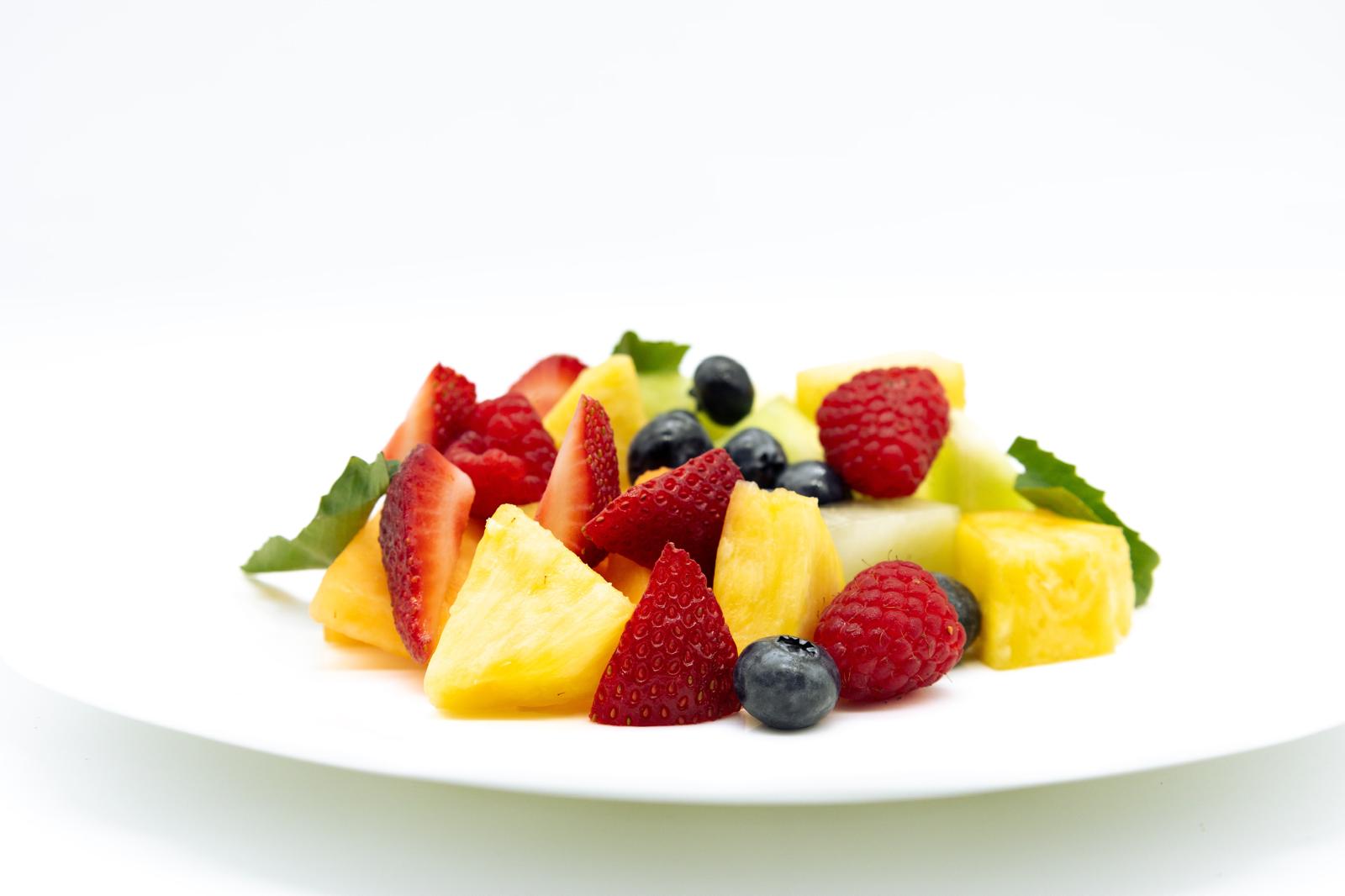 a slice of cake with fruit on a plate